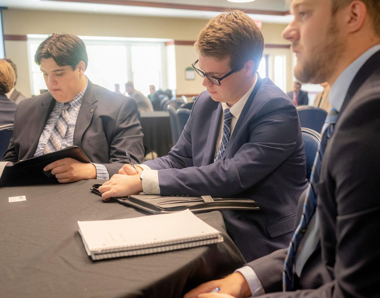 Business students take notes during a seminar