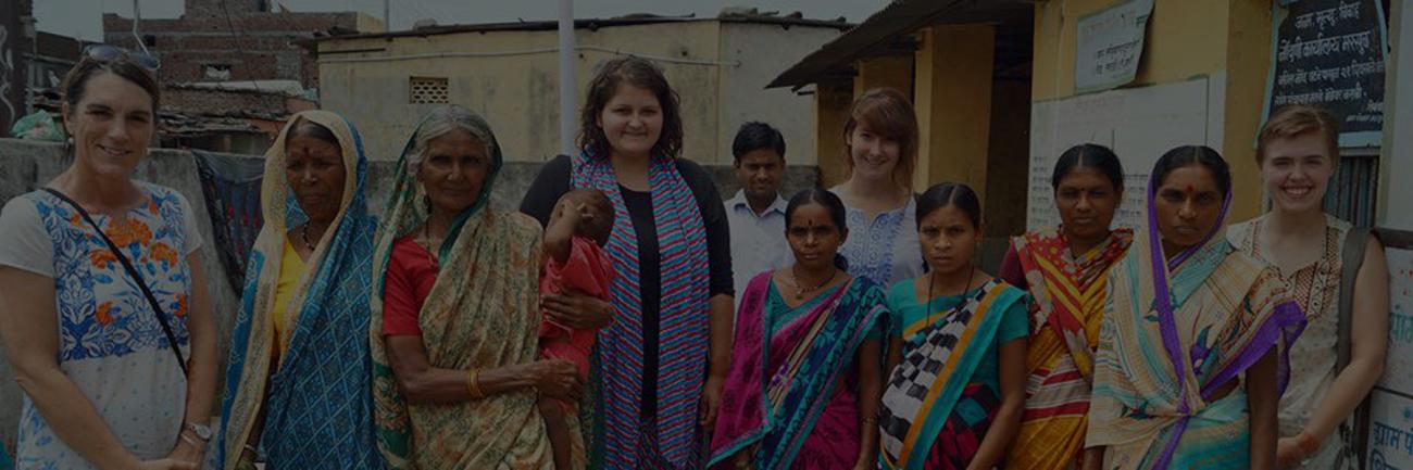 Pre-medicine major Grace Eberly with female health center workers