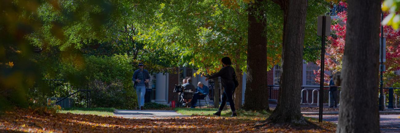 Students walk on College Green in front of Gordy Hall.