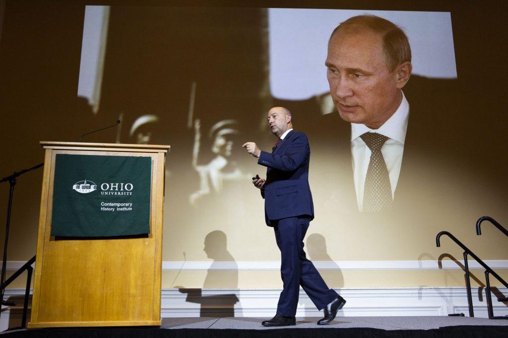 Baker Peace Conference event, with Putin on the big screen behind the speaker