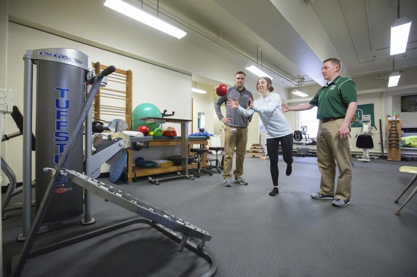 students balancing and throwing a ball