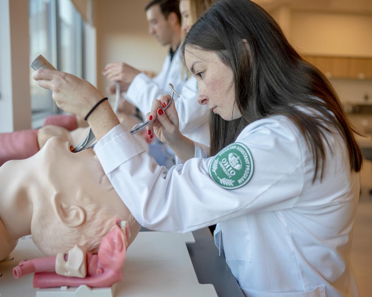 Physicians Assistant student performs a medical exam on a dummy patient