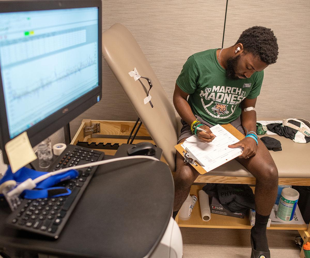 An exercise physiology lab patient completes a questionnaire prior to testing.