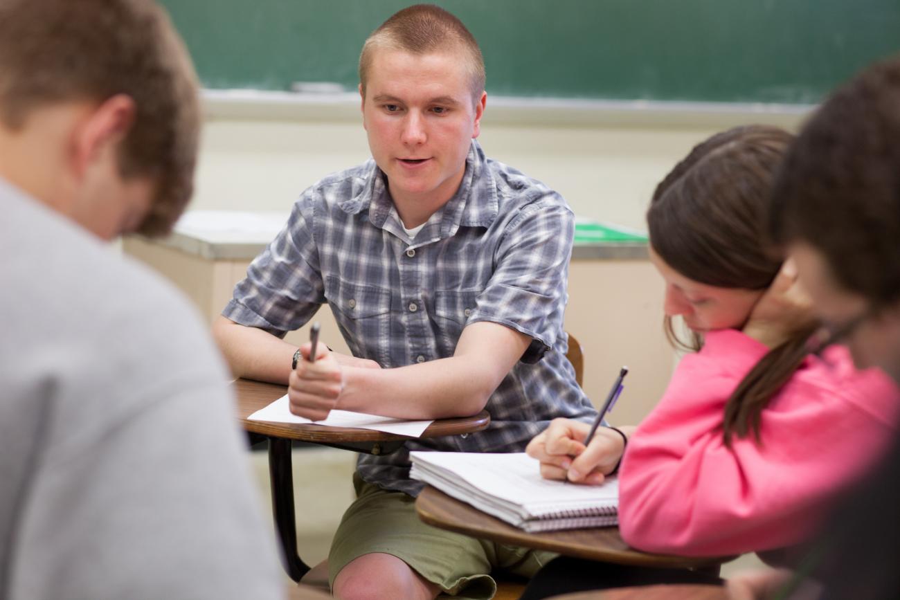 Students sitting at desks talking