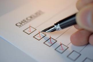 A person checking off boxes of tasks they have completed.