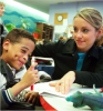 Special education student working with a teacher.