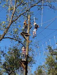 Students climbing on the High Ropes course at The Ridges.