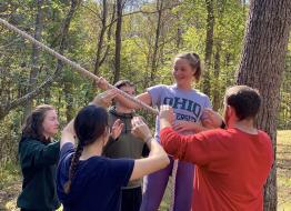 Students working together on a low ropes course.