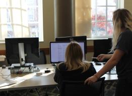 Center for Technology and Online Programs Computer Lab Graduate Assistant helping a student