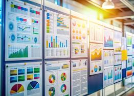 Row of colorful display boards with charts of data.