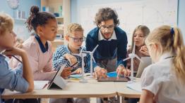 Teacher helping students with an assignment.