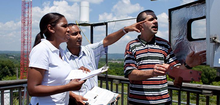 People standing in front of air quality equipment