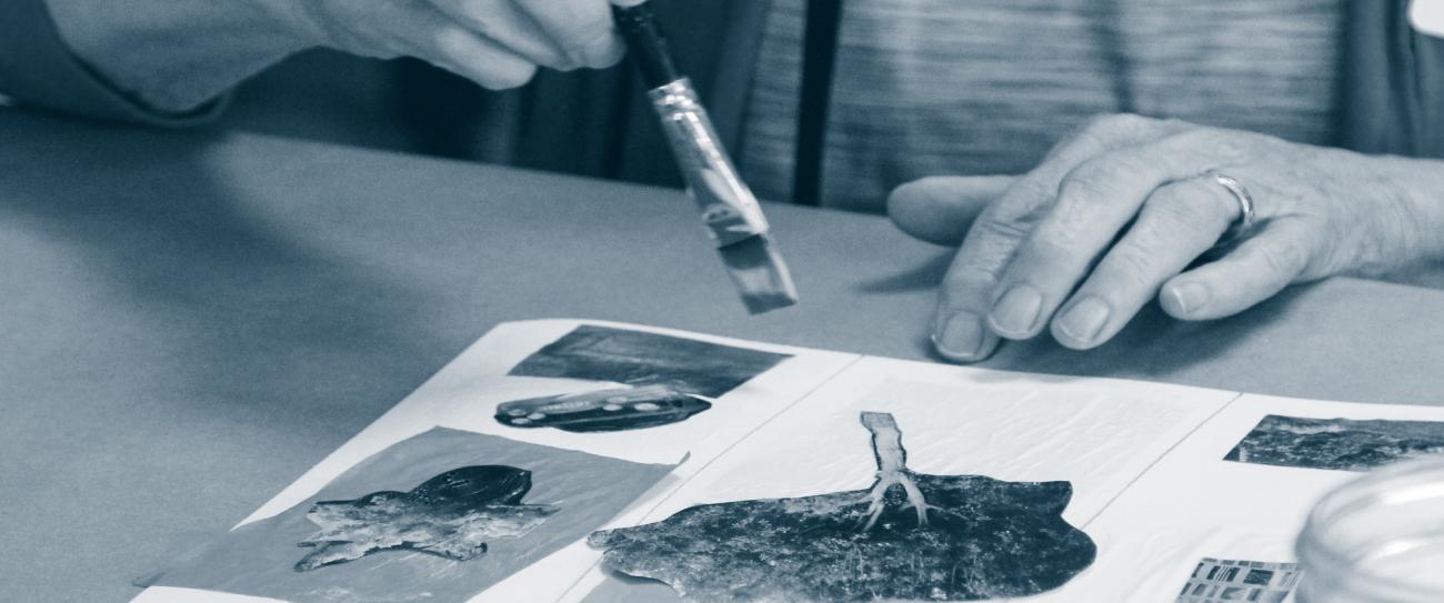 hands hold a paintbrush