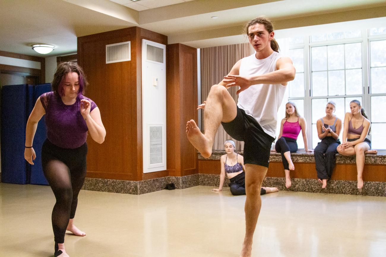 students dance and gesture in studio space