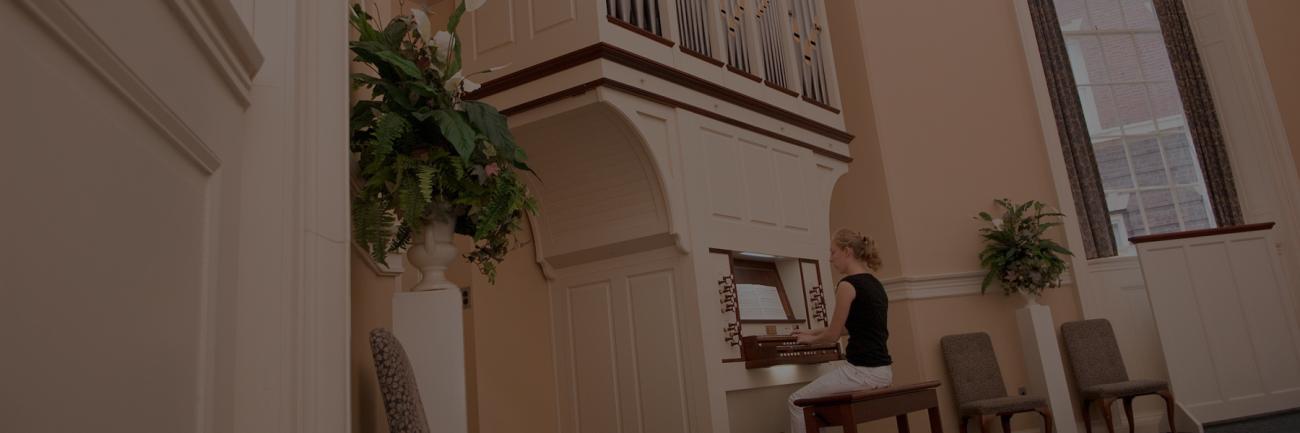A student plays the organ housed in Galbreath Chapel
