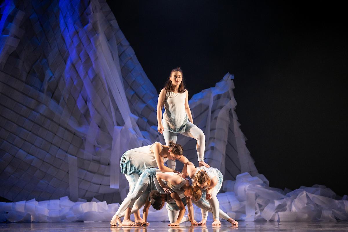 group of dancers on stage during dance performance