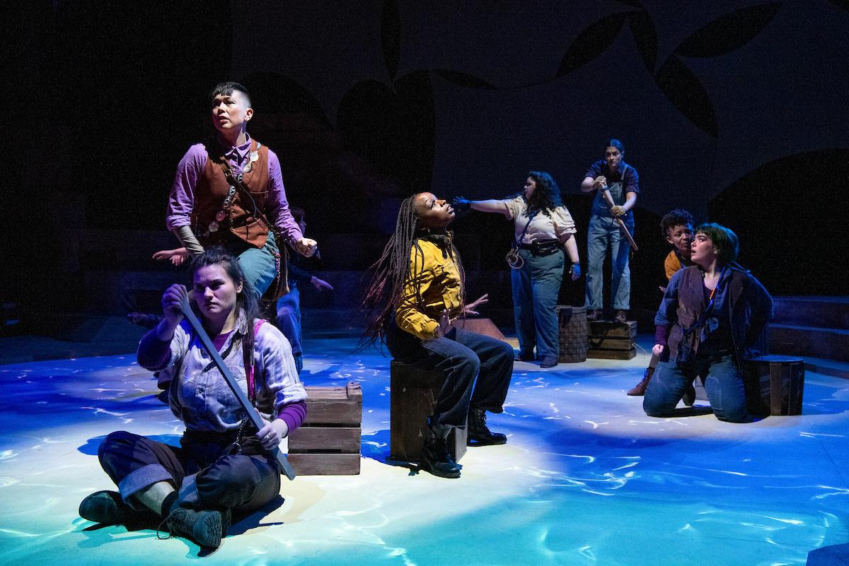 7 people on stage during a play performance