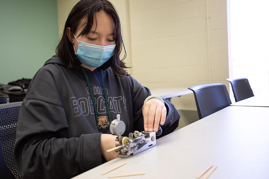 Student making an oboe reed