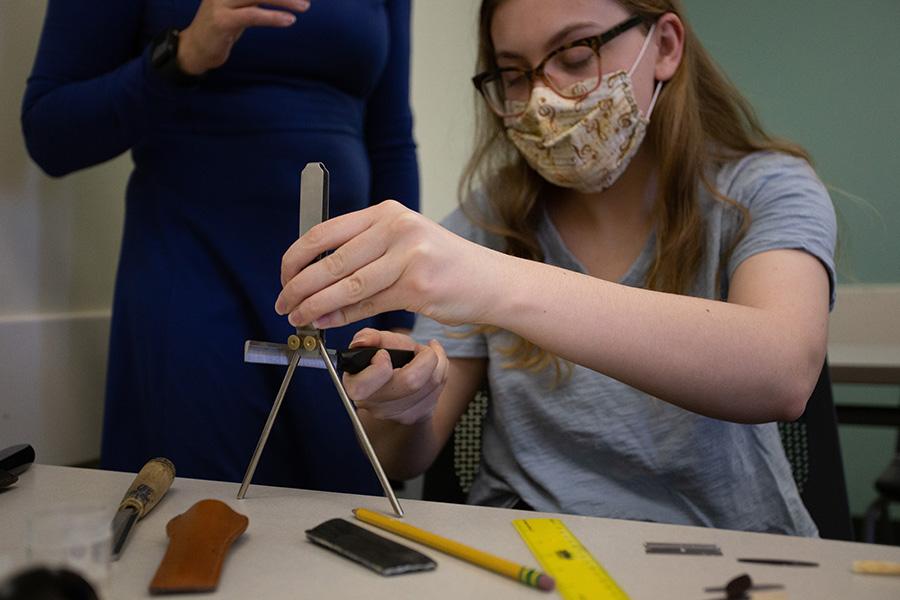 Student making a reed for Oboe