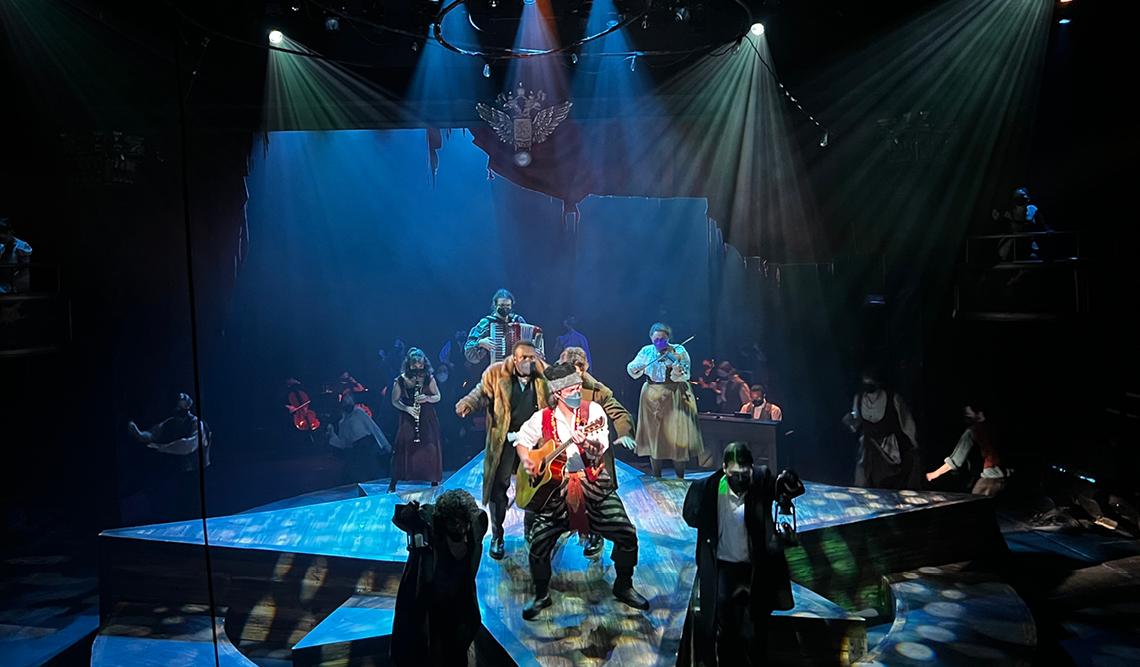 Group of actors on stage playing instruments