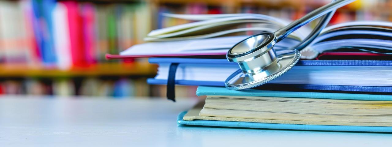 Image of medical books and a stethoscope