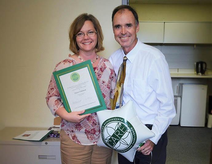Diana Coleman holding award