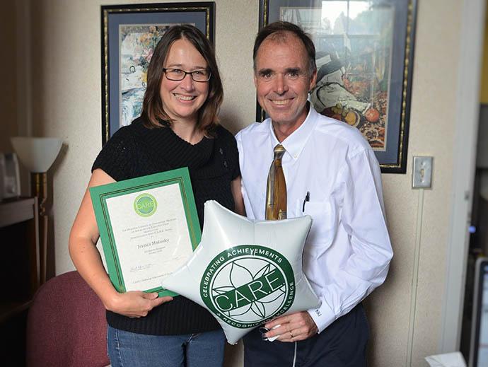 Jessica Makosky holding award