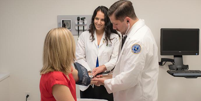 Student and mock patient in exam room