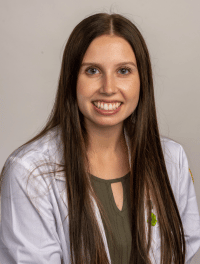 Head shot of student in their white coat
