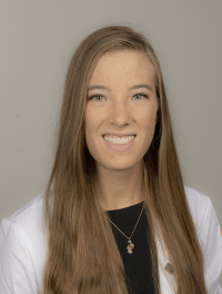 Head shot of student wearing their white coat