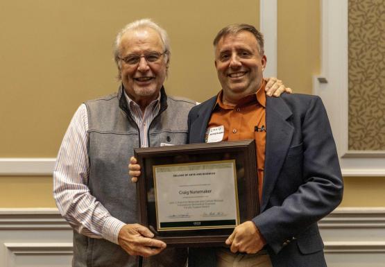 Kopchick and Nunemaker holding award certificate