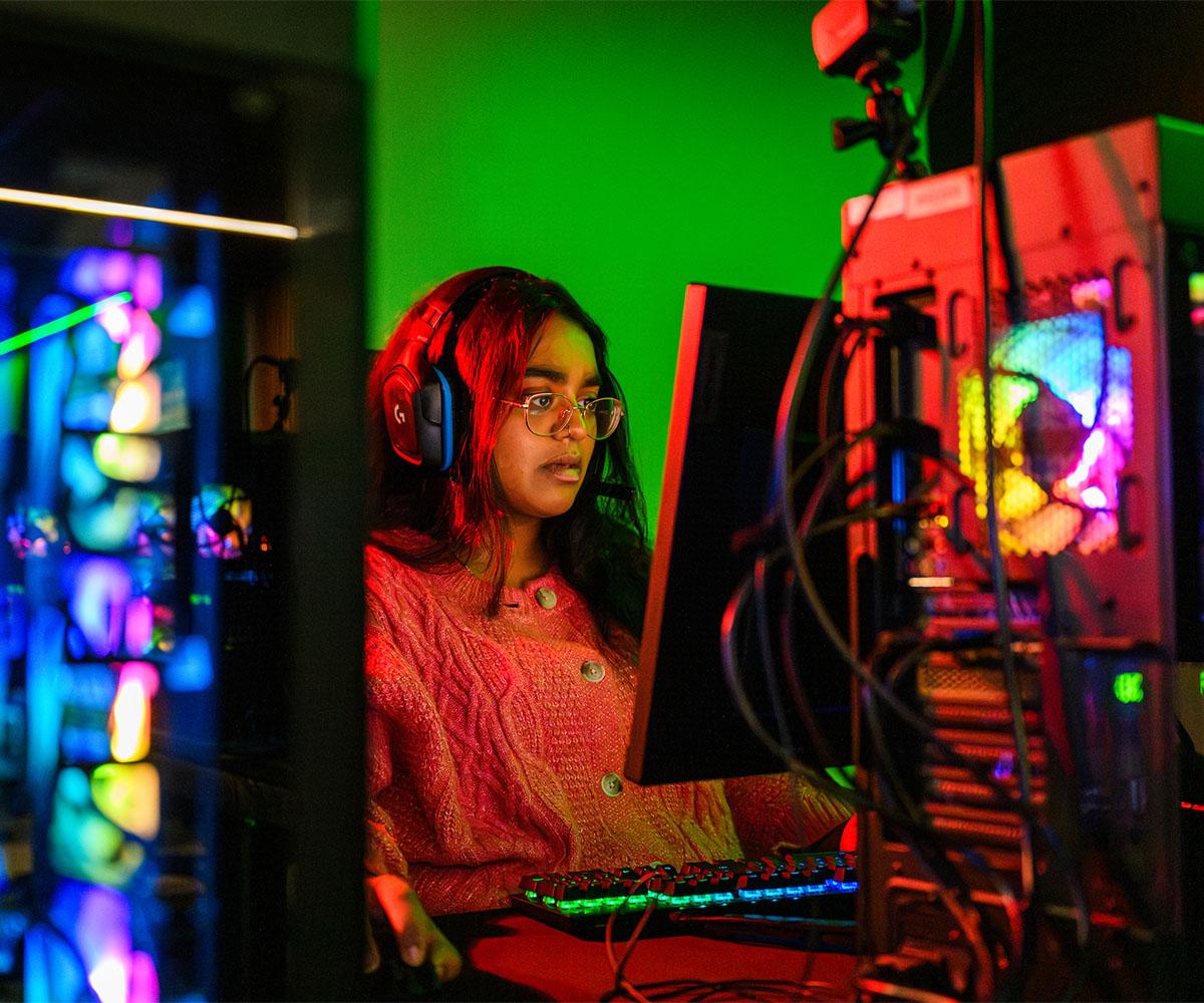 A student works at a computer in the Esports facility.