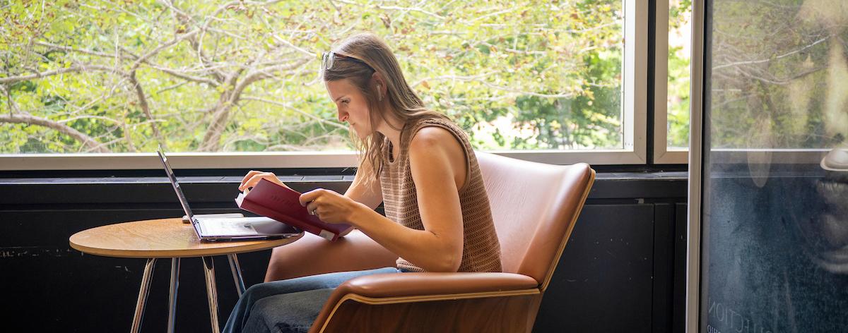 Student sitting in a library studying