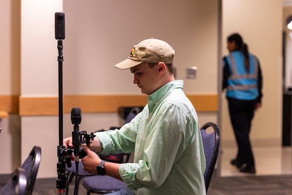 Student sets up a 360 degree camera an microphones