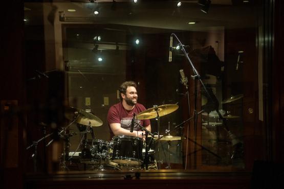 Man playing drums in the recording studio