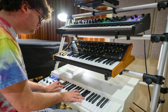 man recording keyboard in the studio