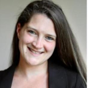 Woman with long hair smiling in headshot
