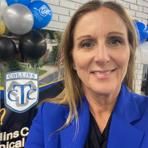headshot of Jacki Adkins, wearing blue blazer