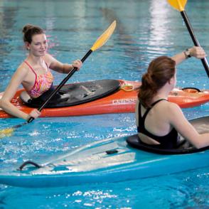 two people kayaking in aquatic center 
