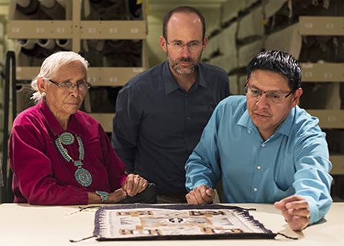 Patrons of the arts, Sally Fowler, Bob Klein and Henry Fowler viewing artwork analyzing its content.