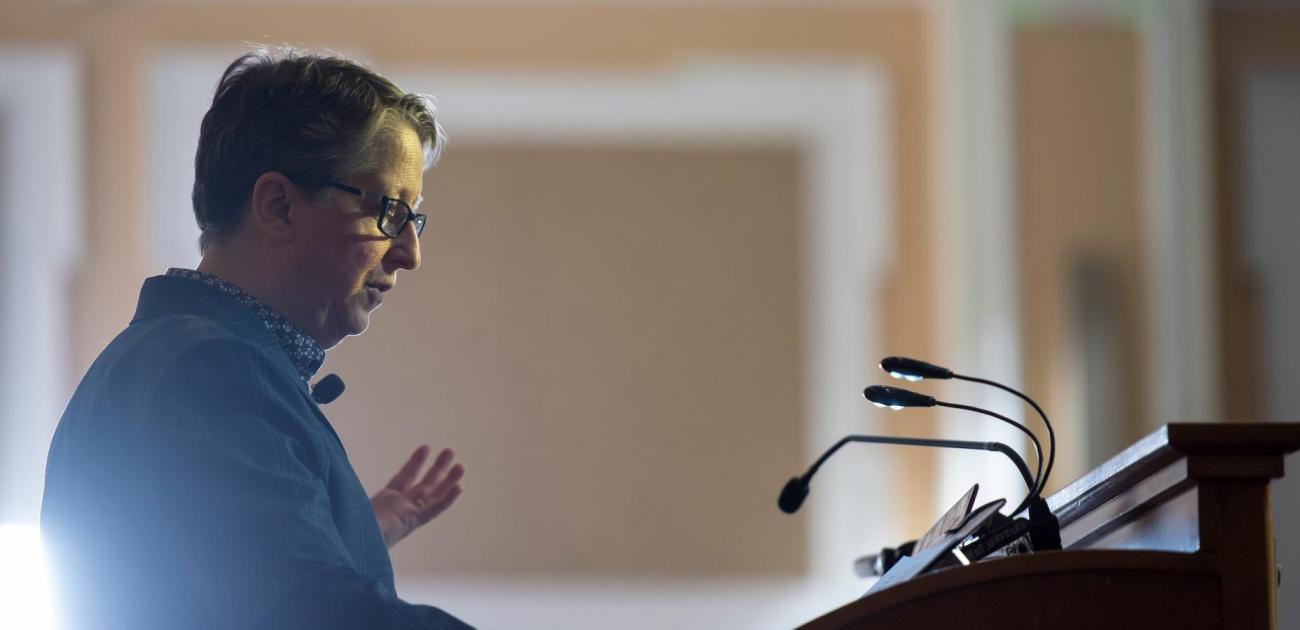 Instructor giving a lecture at a podium.