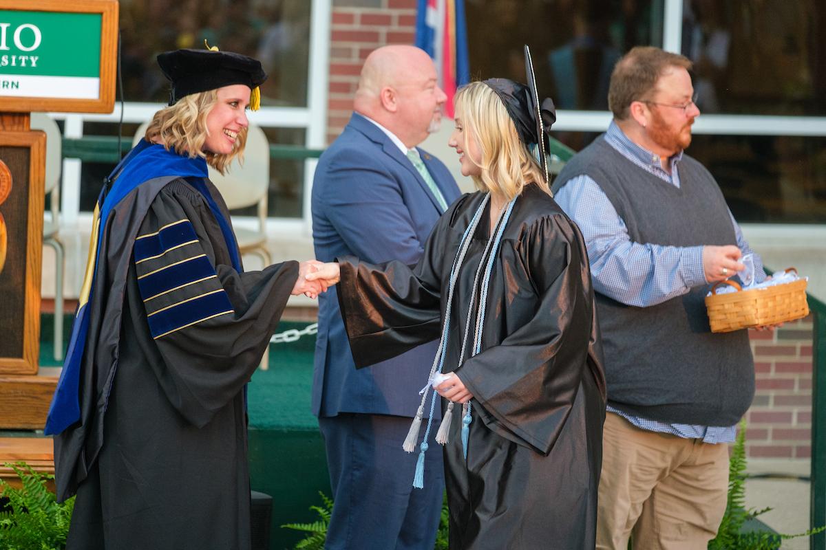 Dean Marinski shaking hands with graduate