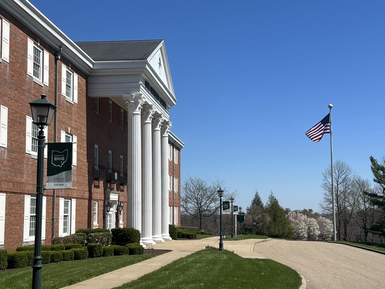 Shannon Hall, front of a brick building with white pillars at the entrance.