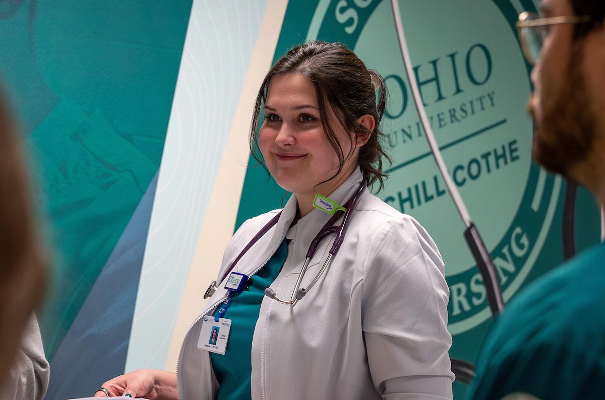 A nursing student at Ohio University's Chillicothe regional campus smiles at someone out of frame
