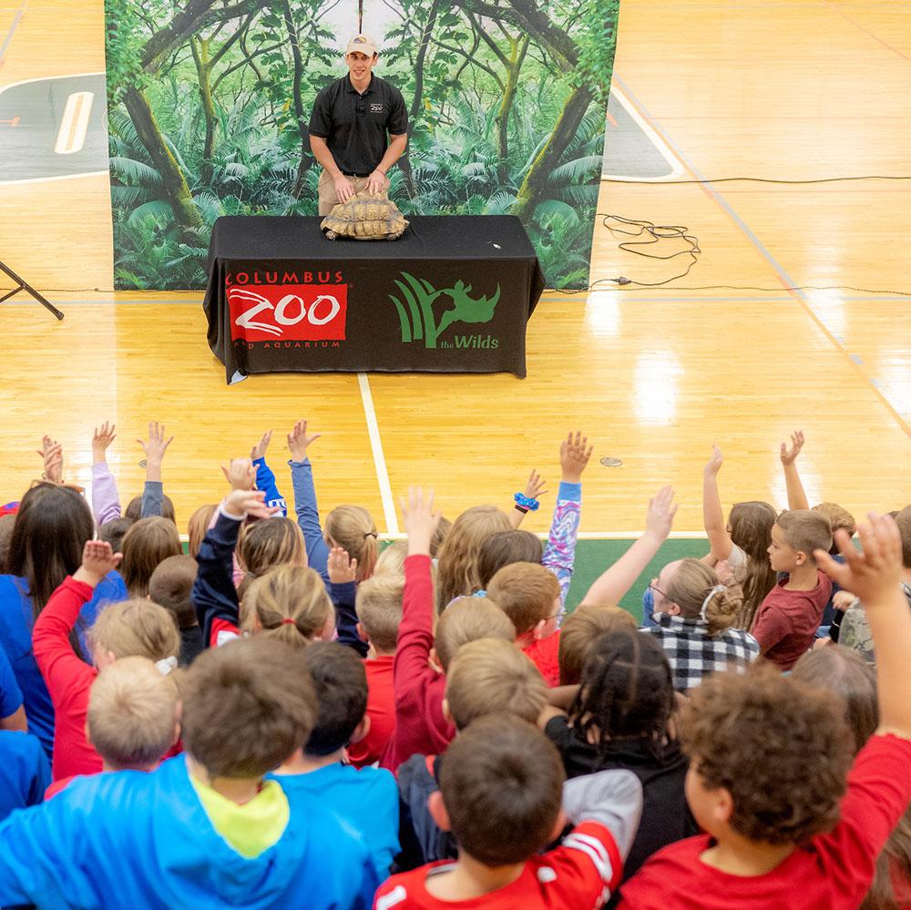 A speaker from the Columbus Zoo teaches Kids on Campus students about a tortoise.