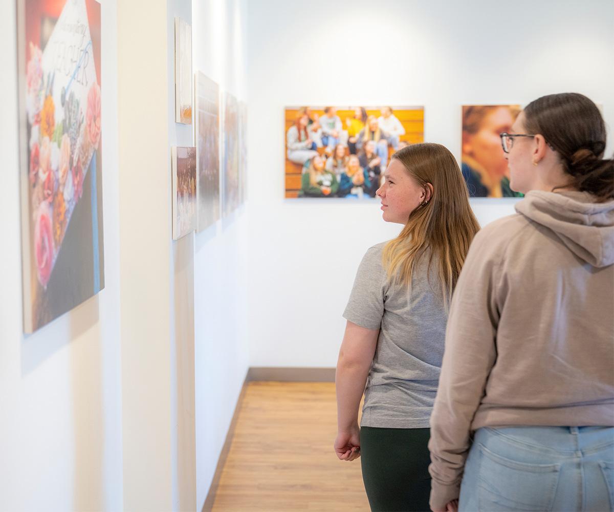 Students look at art in the Art Gallery.