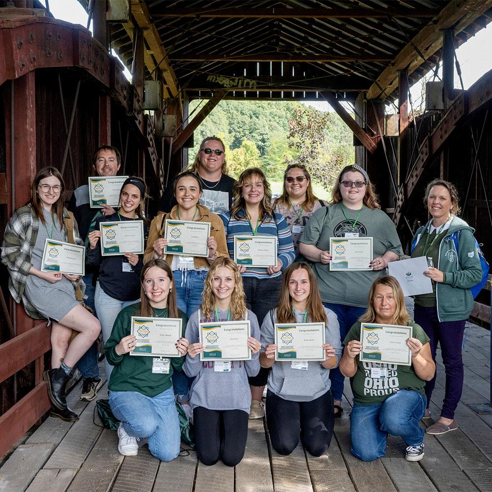 Students pose for a photo after completing an activity.