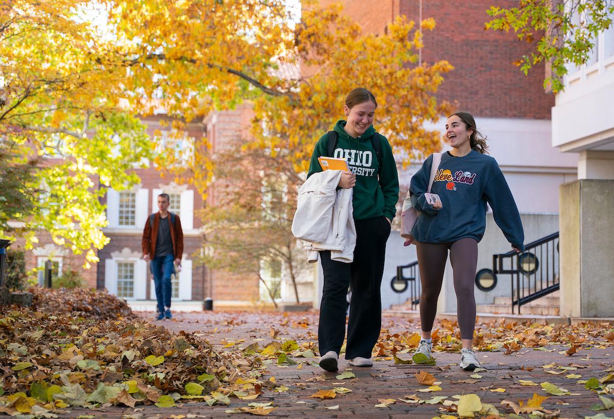 Two students walk in front of Alden Library at Ohio University