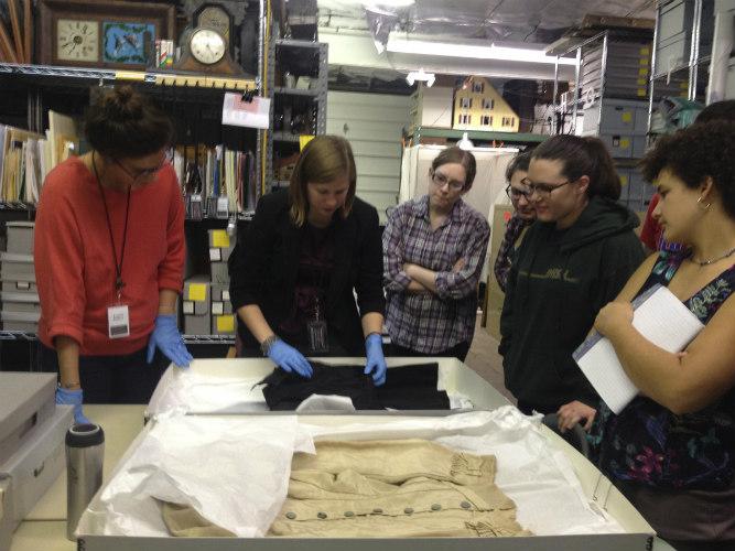 People unraveling an artifact 