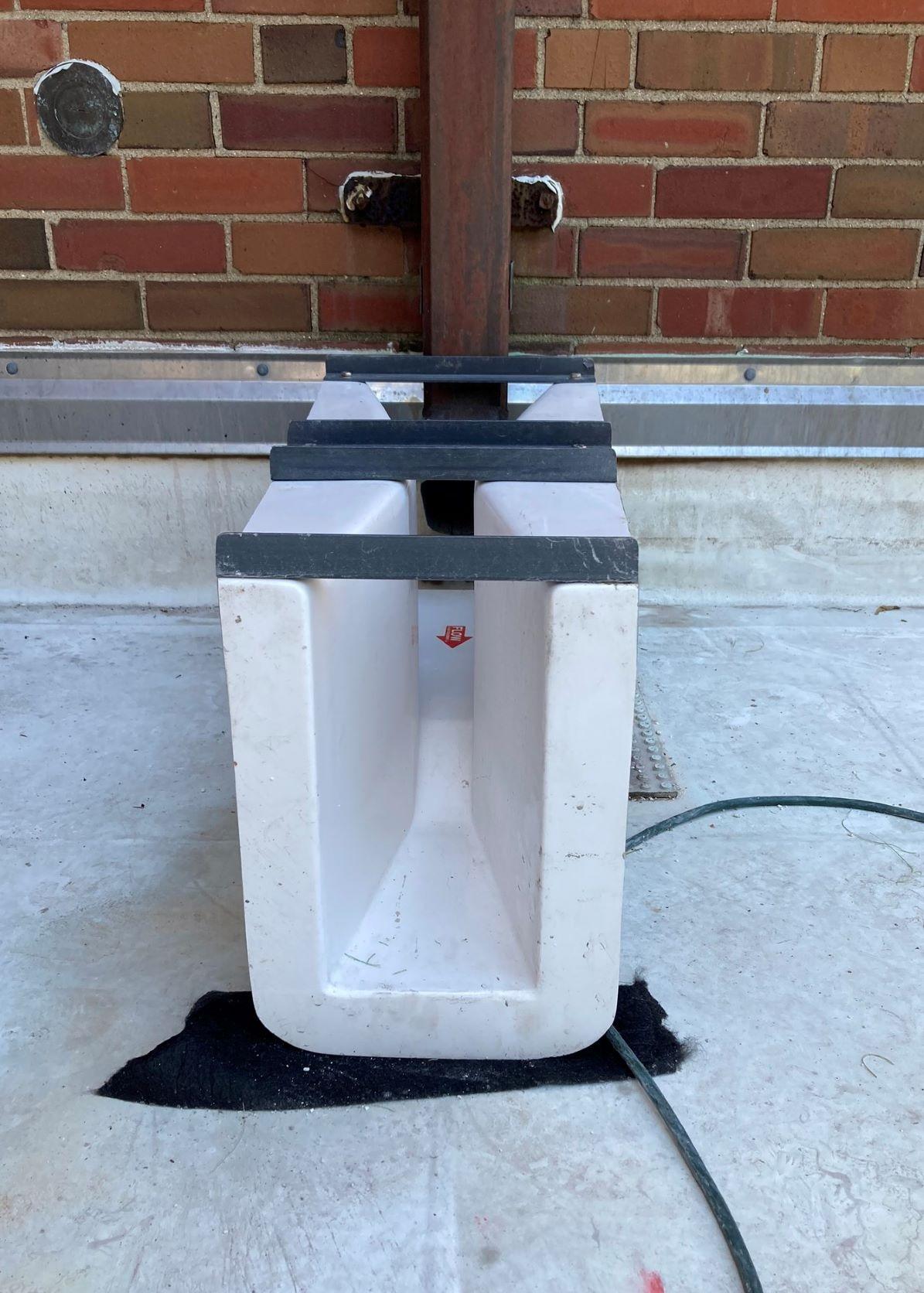 a plastic device that funnels water from the roof